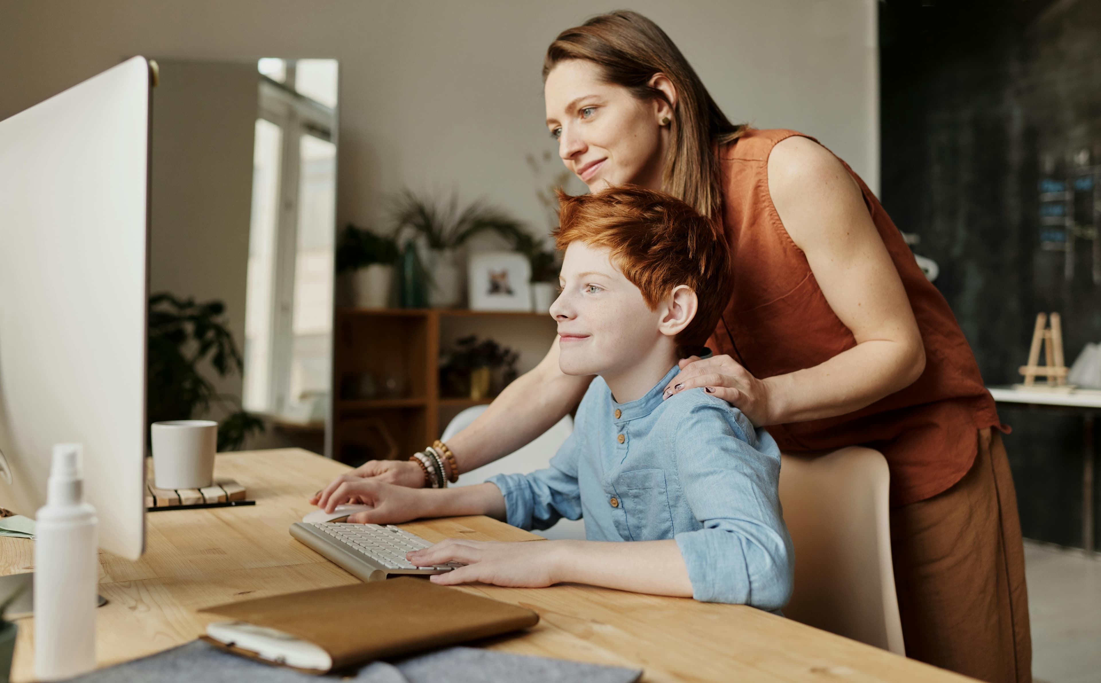 Parent supporting a child's learning at home.